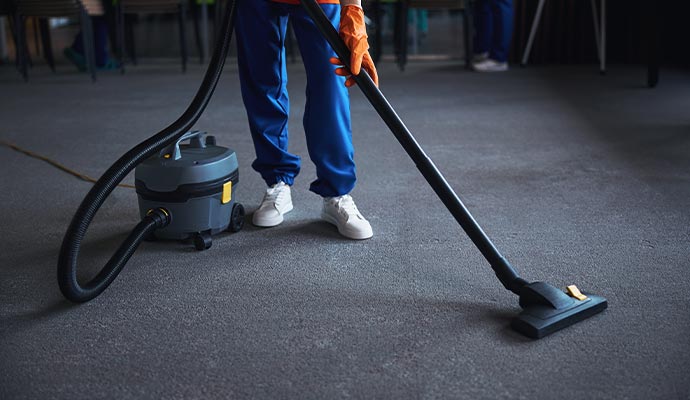 A person is cleaning a carpet