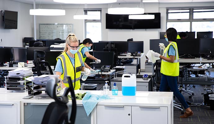 A professional cleaning crew at work in an office environment.