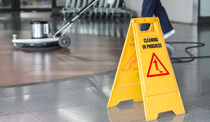 Yellow caution sign warning of wet floor cleaning