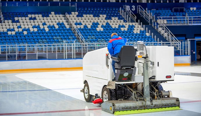 A large cleaning machine in a stadium to perform post sport cleanup service