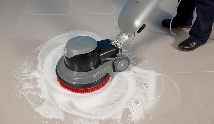 Tile floor cleaning with industrial floor cleaning machine.