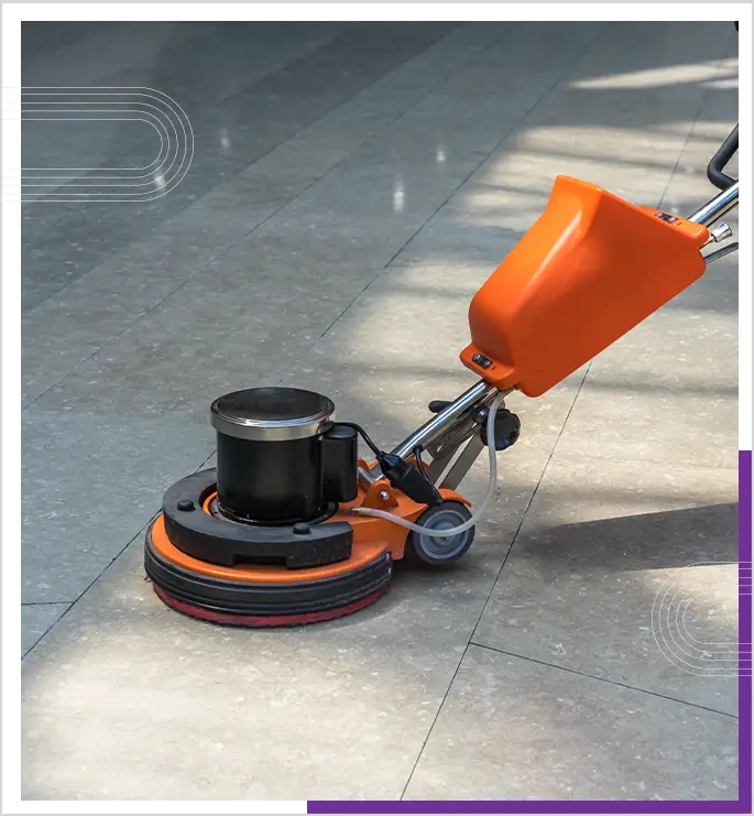 A person is cleaning a floor using a floor cleaning machine.