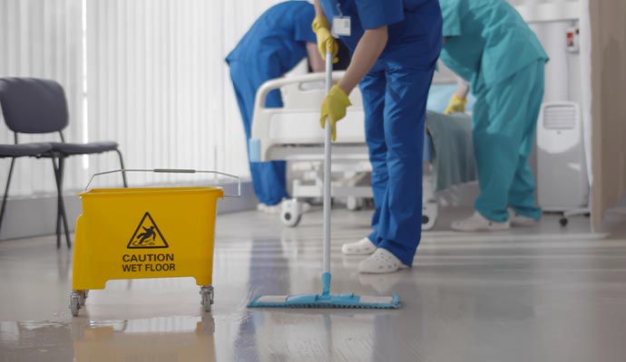 A person cleaning hospital floor