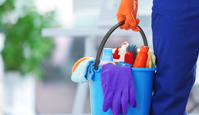 A bucket filled with various eco friendly cleaning products